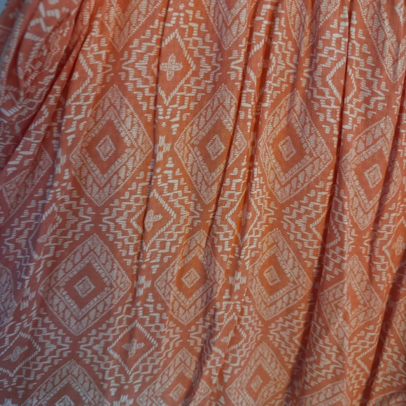 Orange and white patterned Torrid cold shoulder top with sleeves. - Picture 2 of 5